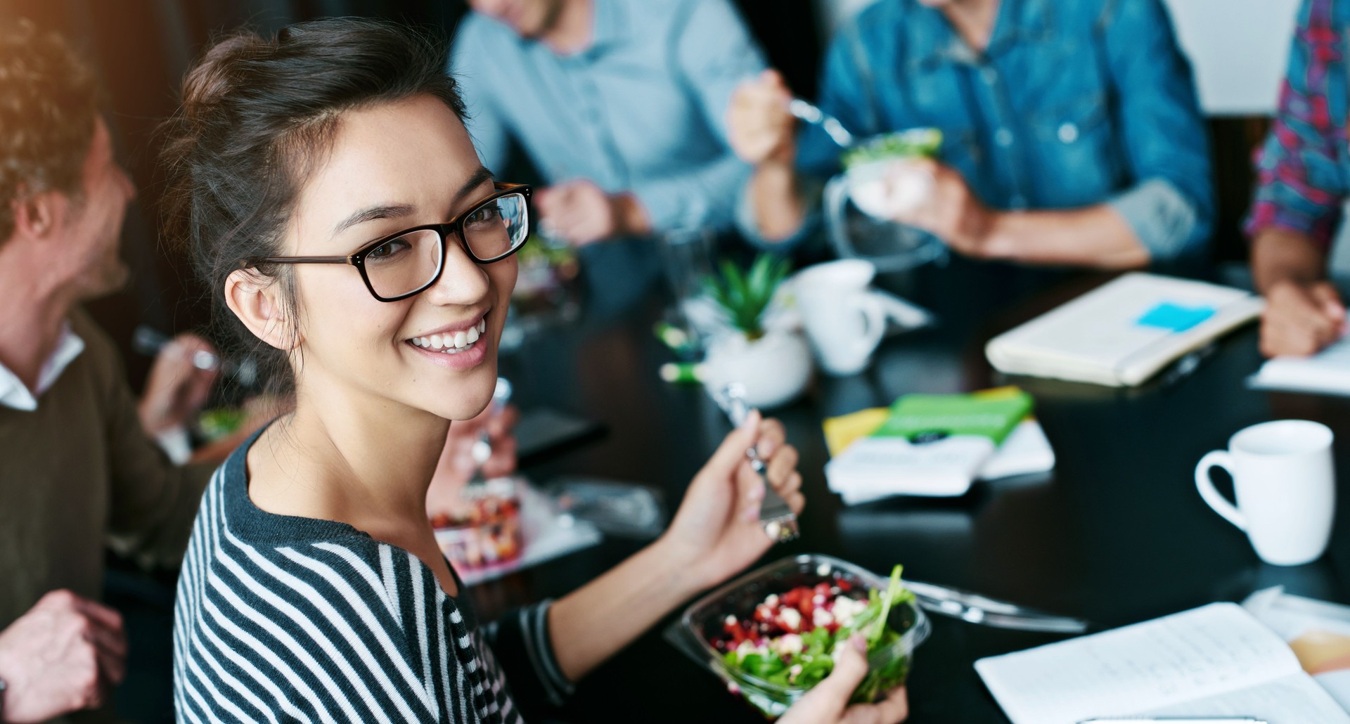 Woman, portrait and lunch at meeting in office with smile, healthy salad and team building for business. Professional, employee and food in boardroom for collaboration, partnership and happy by table