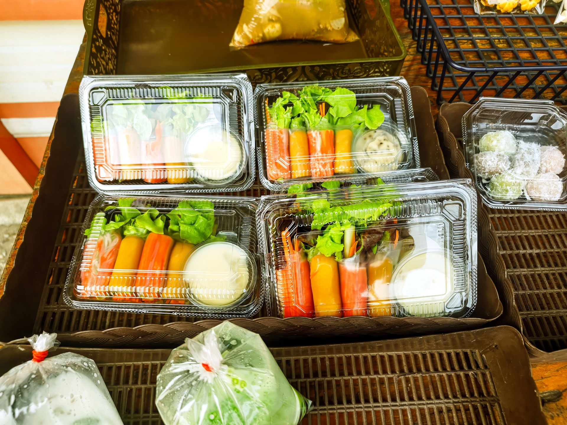 Photo of healthy salad boxes for sale at a street food stall, Chiang Mai, Thailand.